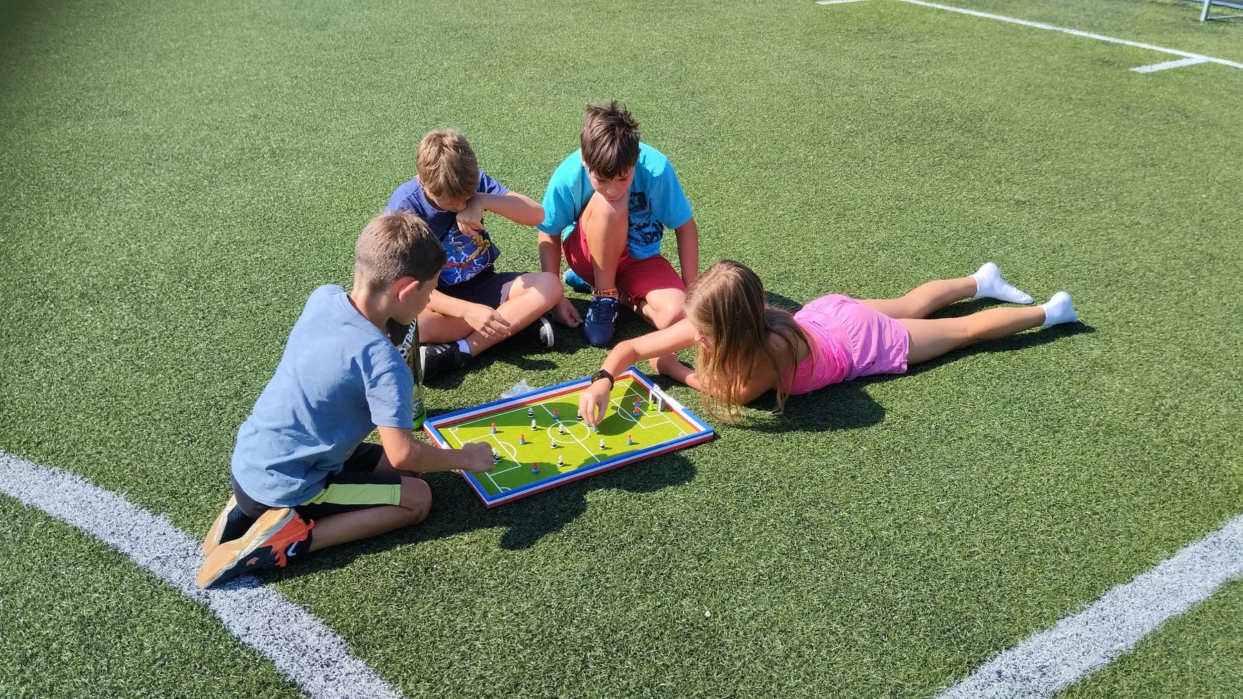 Children playing Footballec outdoors on a sports field